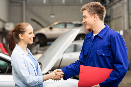 Female Shaking Hands With Car Mechanic